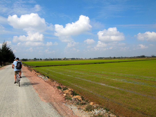 A tourist takes a bike ride in the country A tourist takes a bike ride in the country